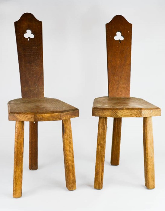 A pair of Welsh oak chairs, with pierced back, and three morticed legs.