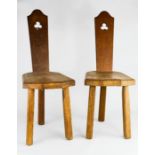 A pair of Welsh oak chairs, with pierced back, and three morticed legs.