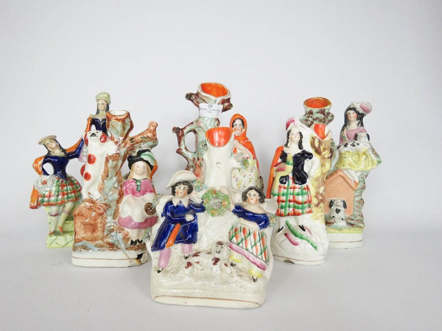 A group of 19th century Staffordshire figure groups, including seven posy holders, the tallest