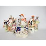 A group of 19th century Staffordshire figure groups, including seven posy holders, the tallest