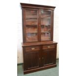 An Edwardian mahogany bookcase, the glazed upper cabinet above a cupboard below.