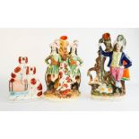 Three 19th century Staffordshire posy holders, and a dog group, the tallest 32cm high.