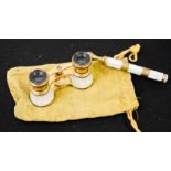 A pair of mother of pearl and gilt brass Iris of Paris opera glasses, with handle, with pouch.