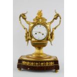 A 19th century French ormolu mantle clock, by Gaston Joly, with a Roman Numeral dial, flanked with