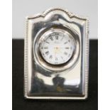 A silver clock, by R Carr, with Roman numeral dial, 9cm high.