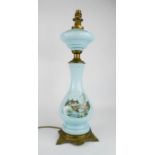 A pale blue glass lamp base, painted with a landscape.