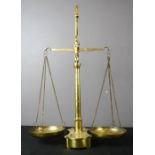 A brass antique chemists set of scales, with weights inset to the base.