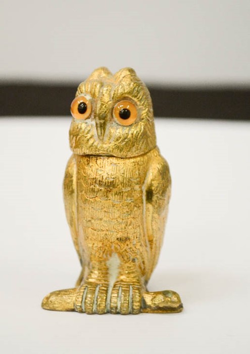 A gilt brass matchbox holder in the form of an owl, with hinged head, 7cm high.