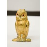 A gilt brass matchbox holder in the form of an owl, with hinged head, 7cm high.