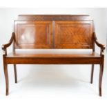 A late 19th / early 20th century mahogany hall seat, with a blind fret carved frieze above quarter