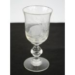 A wine glass etched with a hedgehog and monogrammed to the base.
