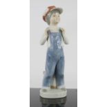 Lladro young boy in dungarees.