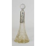 A silver and cut glass perfume bottle, the silver collar embossed with scrollwork, 23cm high.