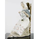 Lladro; seated lady sewing.