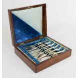 A set of Victorian six fish knives and forks with blue velvet lining.