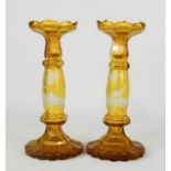 A pair of yellow glass Bohemian candlesticks, etched with stag in woodland, 24cm high.