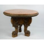 A 19th century marble top centre table, the circular red marble top above a triform base, carved