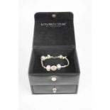 A Love Links bracelet, in the original box with drawer and further beads.