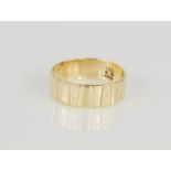 A 9ct gold wedding band with bark effect.
