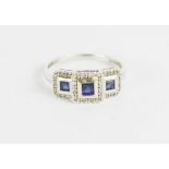 A 10k white gold ring, set with three square cut sapphires, size P/Q 2.4g.