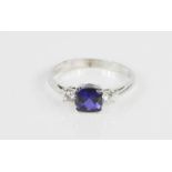 An 18ct white gold and cabochon sapphire ring, flanked by diamonds, 3.4g.