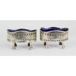 A pair of silver oval Victorian salts, Birmingham 1854, raised on ball and claw feet, with matched