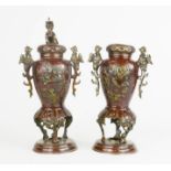 A pair of Chinese bronze censors, with dog of fo finialled covers, red patination, 33 cm high, A/F.