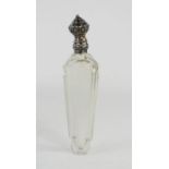 A French glass perfume bottle with white metal lid.