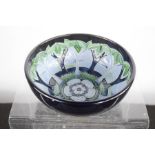 A Moorcroft trial piece bowl, created with trees with floral rosette to the centre Nova Foresta,