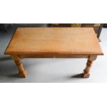 A pine coffee table with short turned legs.