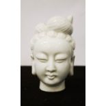 A blanc de chine ceramic Buddha head, 13cm high.