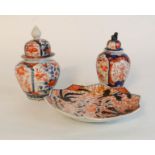 Two Chinese Imari jars and covers, together with a starburst form dish, the tallest 16cm high.