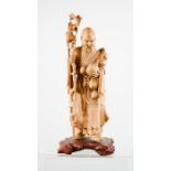 A Chinese carved figure of the God of Longevity, 30cm high.