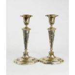 A pair of candlesticks, Birmingham 1950, with weighted bases, 28cm high.