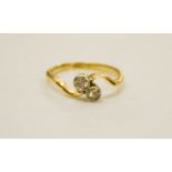 An 18ct gold and twin old cut diamond ring, size M, 2.7g.