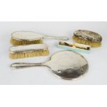 A silver dressing table set, to include hair brush, clothes brush, hand mirror, a further hand brush