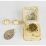 A silver gilt sovereign ring, and a silver pendant.