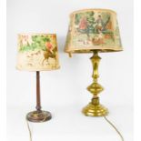 A brass table lamp and a wooden table lamp, with shades depicting fishing and hunting scenes, 60cm