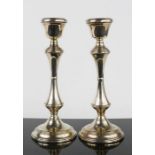 A pair of silver candlesticks, London, with weighted bases, 23cm high.