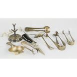 A group of silver plate sugar tongs, together with a silver ring tree.