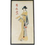 A Japanese needlework depicting a woman playing a pipe, calligraphy to the top left, 46 by 23cm.