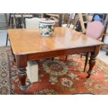 A Victorian extending mahogany dining table.
