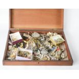 A mahogany box containing assorted costume jewellery and a BOAC badge.