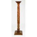 A Victorian mahogany candle / jardinere stand, the column carved with foliage, and raised on