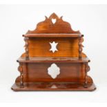 A 19th century mahogany three tier wall shelf, the shaped back pierced with a heart and two