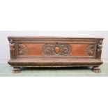 An 18th century Italian Cassone, carved with caryatids, and scrollwork to the centre, raised on