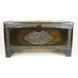 A Chinese camphor wood chest, carved in relief to depict figural vistas, raised on shaped bracket