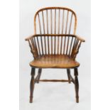 A 19th century elm Windsor arm chair, with bowed top rail pierced with spindles.