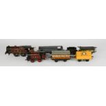 A Hornby LMS 6954 tin plate locomotive, an unmarked tin plate wagon, a Hornby series LNER wagon, LMS