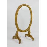 An 18th century French giltwood & gesso oval fire screen, Rococo period, with glazed oval panel.